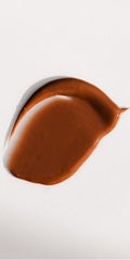 Dr. Hauschka swatch on arm showing natural bronze finish and buildable coverage