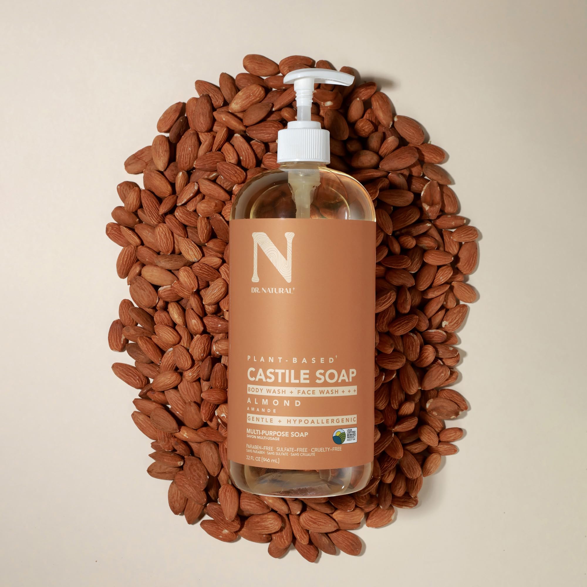 Bottle of Dr. Natural almond soap next to sink for household cleaning use