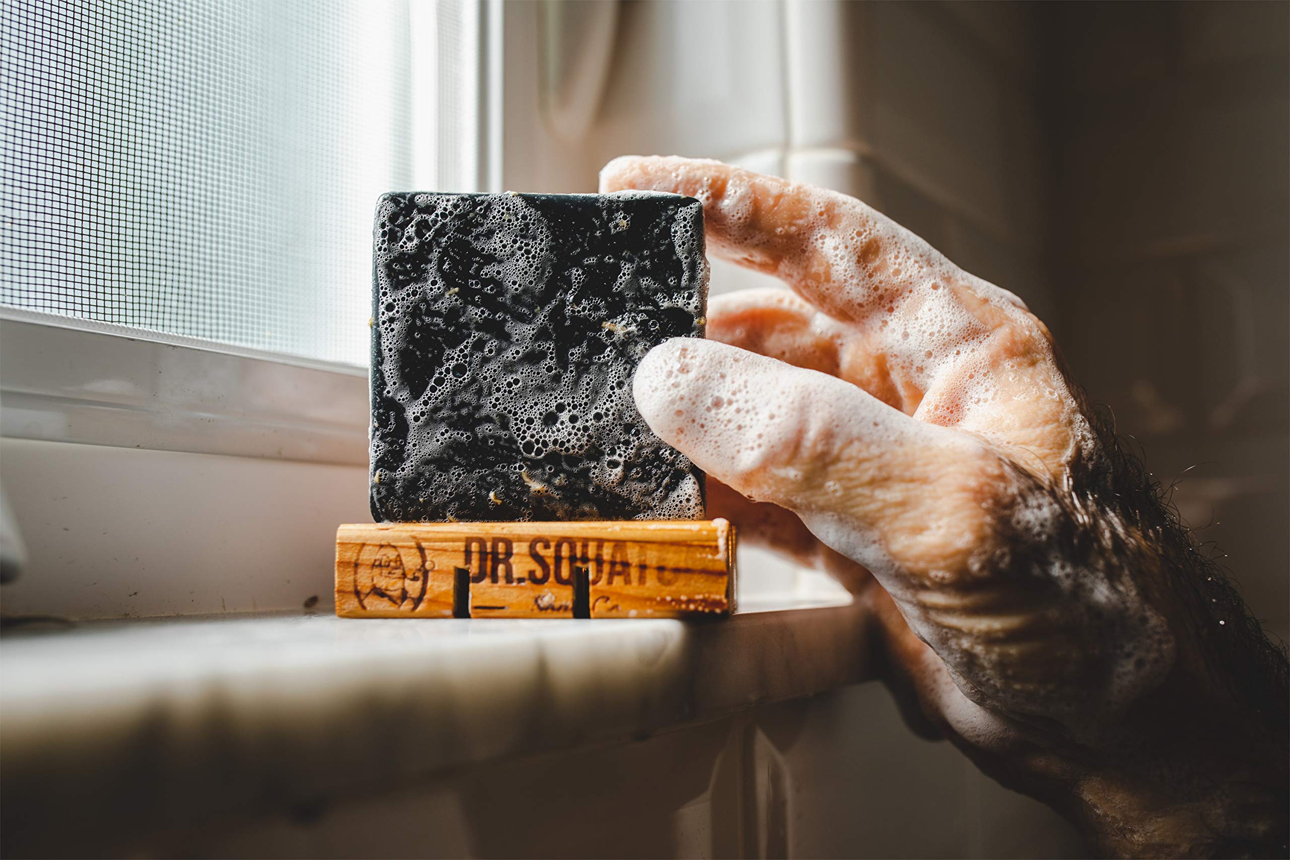 Ingredients label on Dr. Squatch soap showing pine, coconut, olive oils benefits