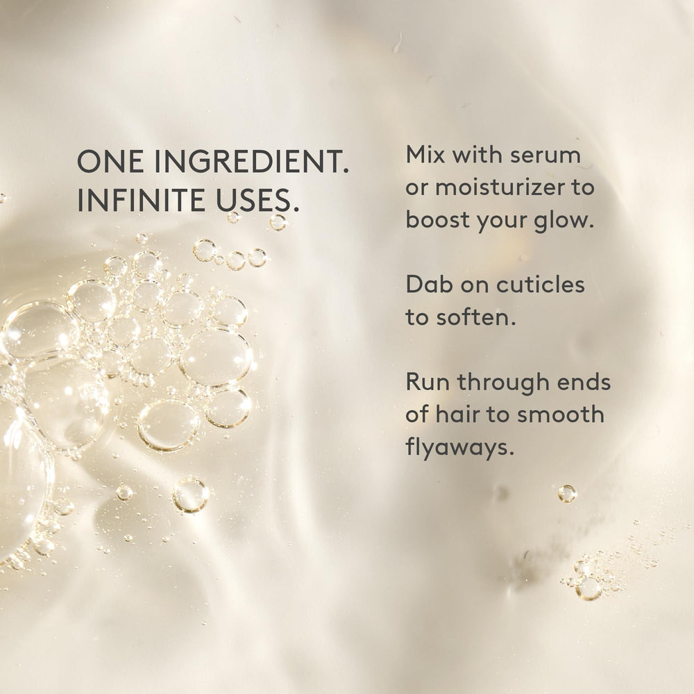 Drunk Elephant marula oil in hand scale view showing compact 15 ml travel-friendly size