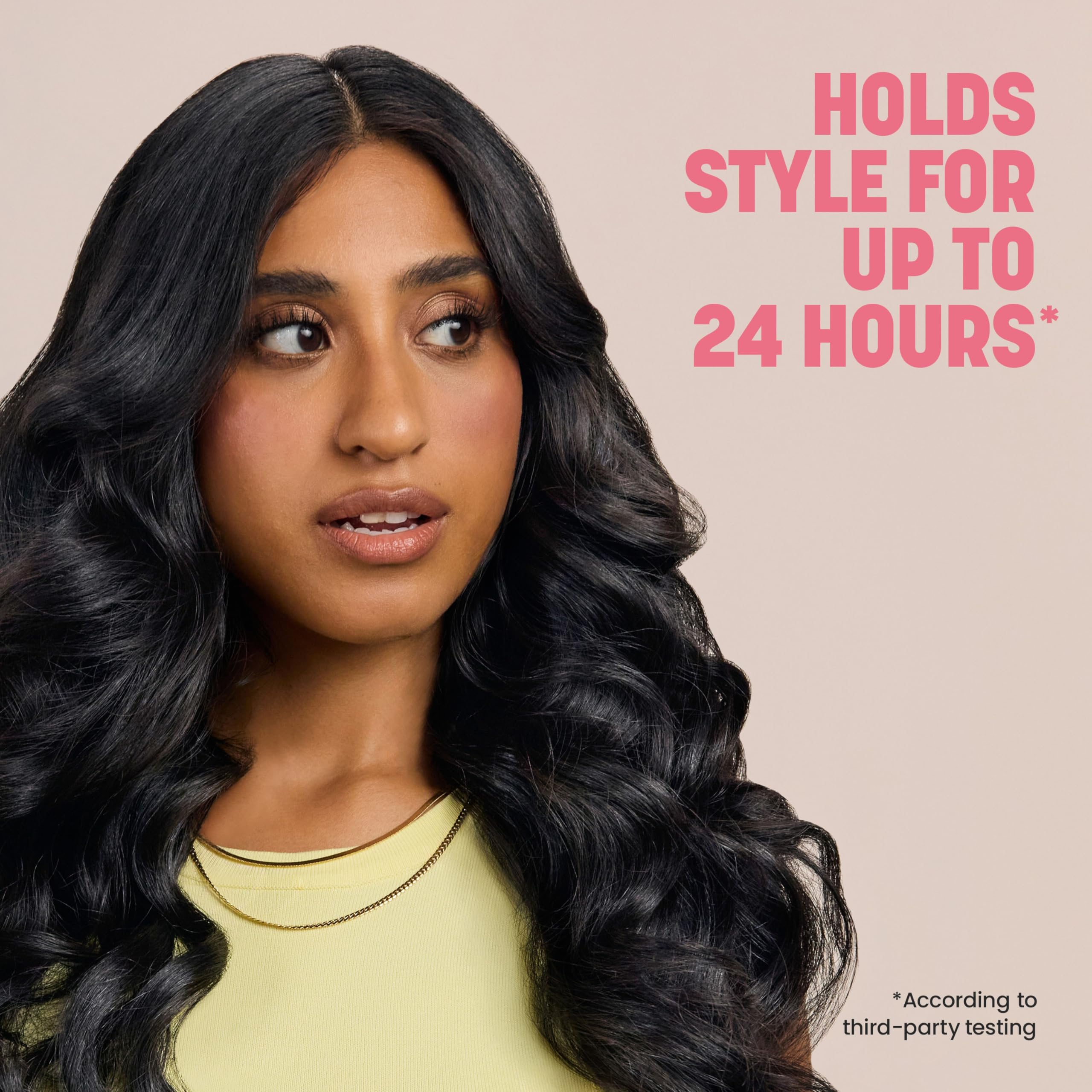 drybar spraying on styled hair to lock curls and boost visible volume