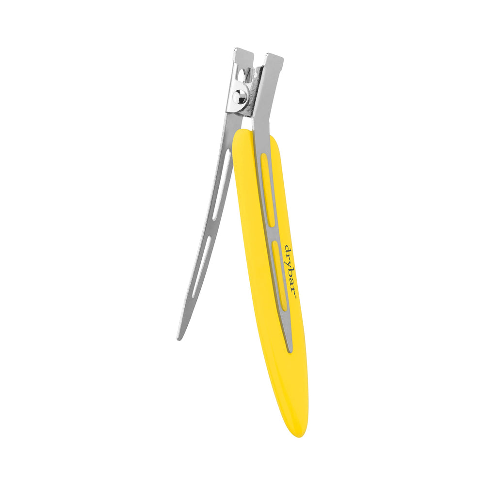 Drybar Tiny Tamers clipping a curl in place to lock shape and reduce dents