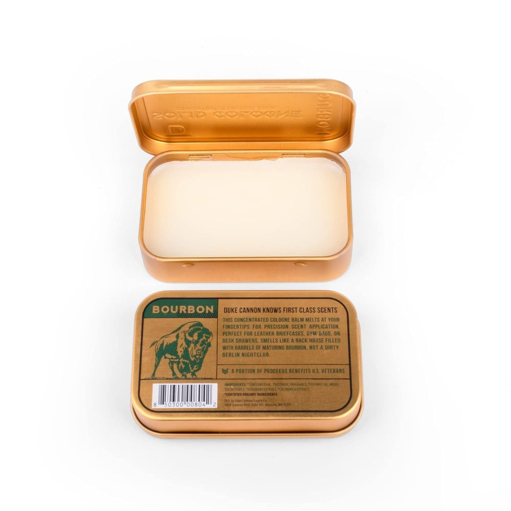 Duke Cannon tin beside travel essentials illustrating on-the-go refresh benefit
