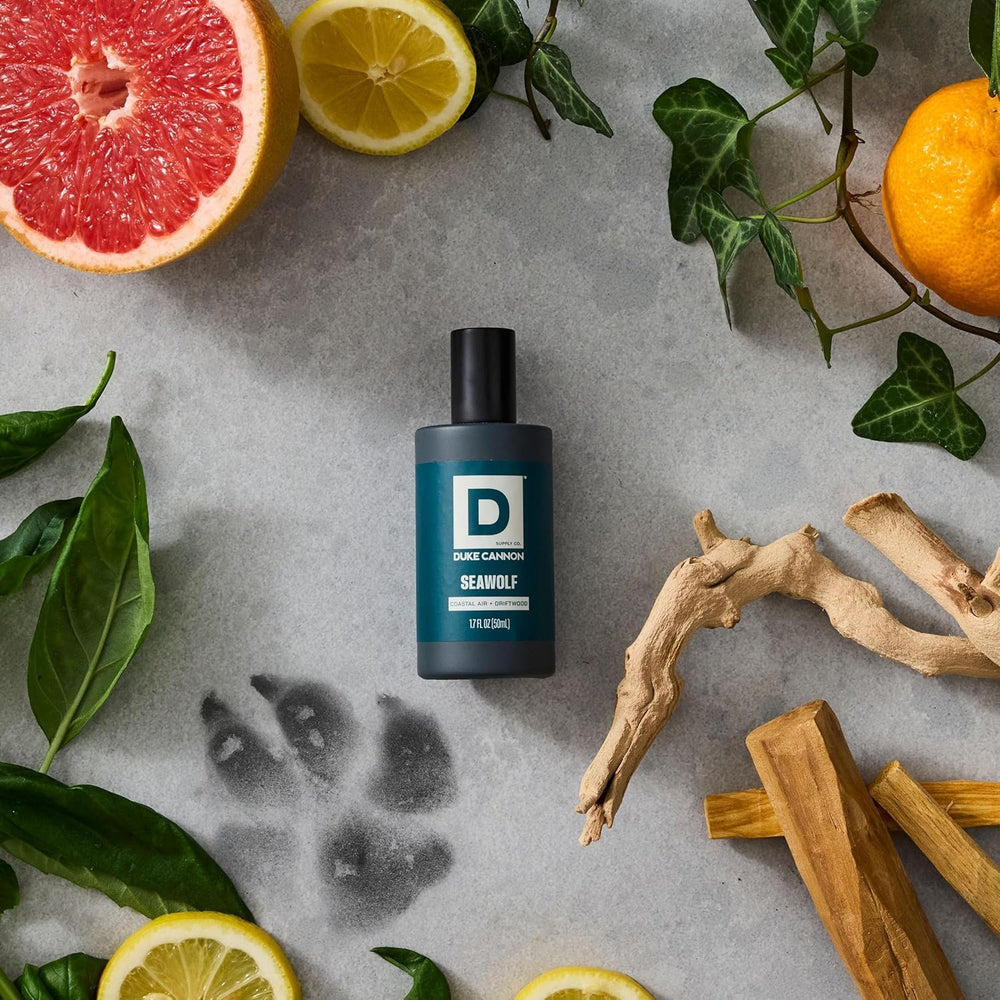 Duke Cannon mini cologne being sprayed on wrist showing convenient application benefit