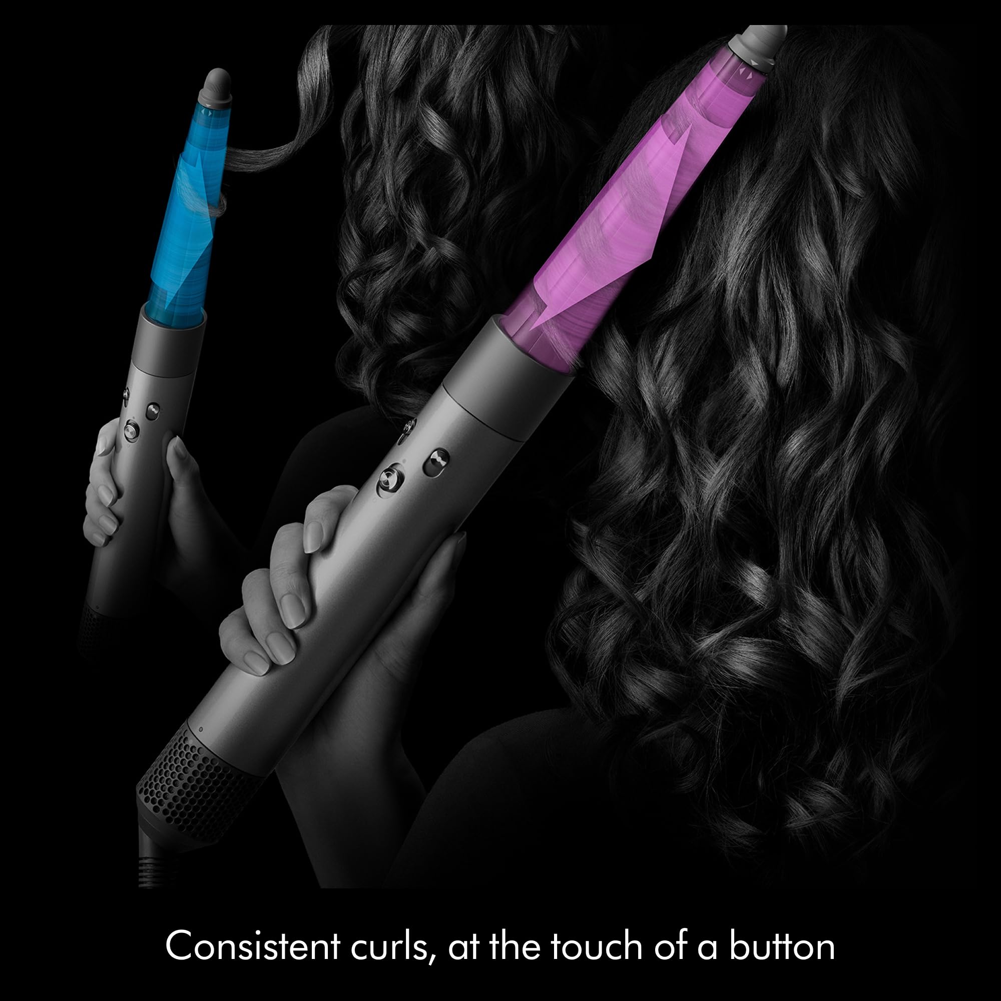 Dyson Airwrap i.d. held next to hand to show scale and travel-friendly size