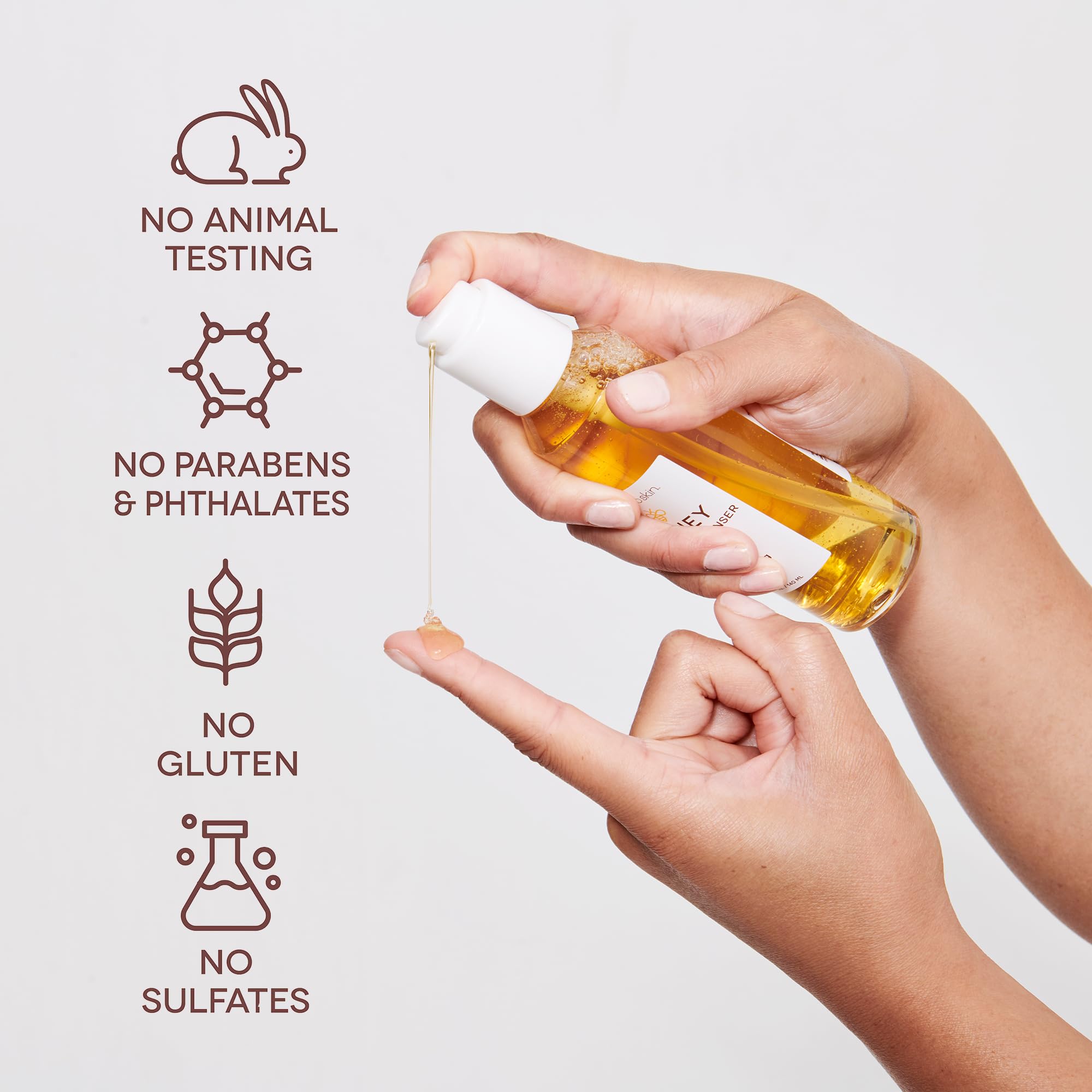 Earth To Skin serum applied to hand to show quick absorption and dewy finish