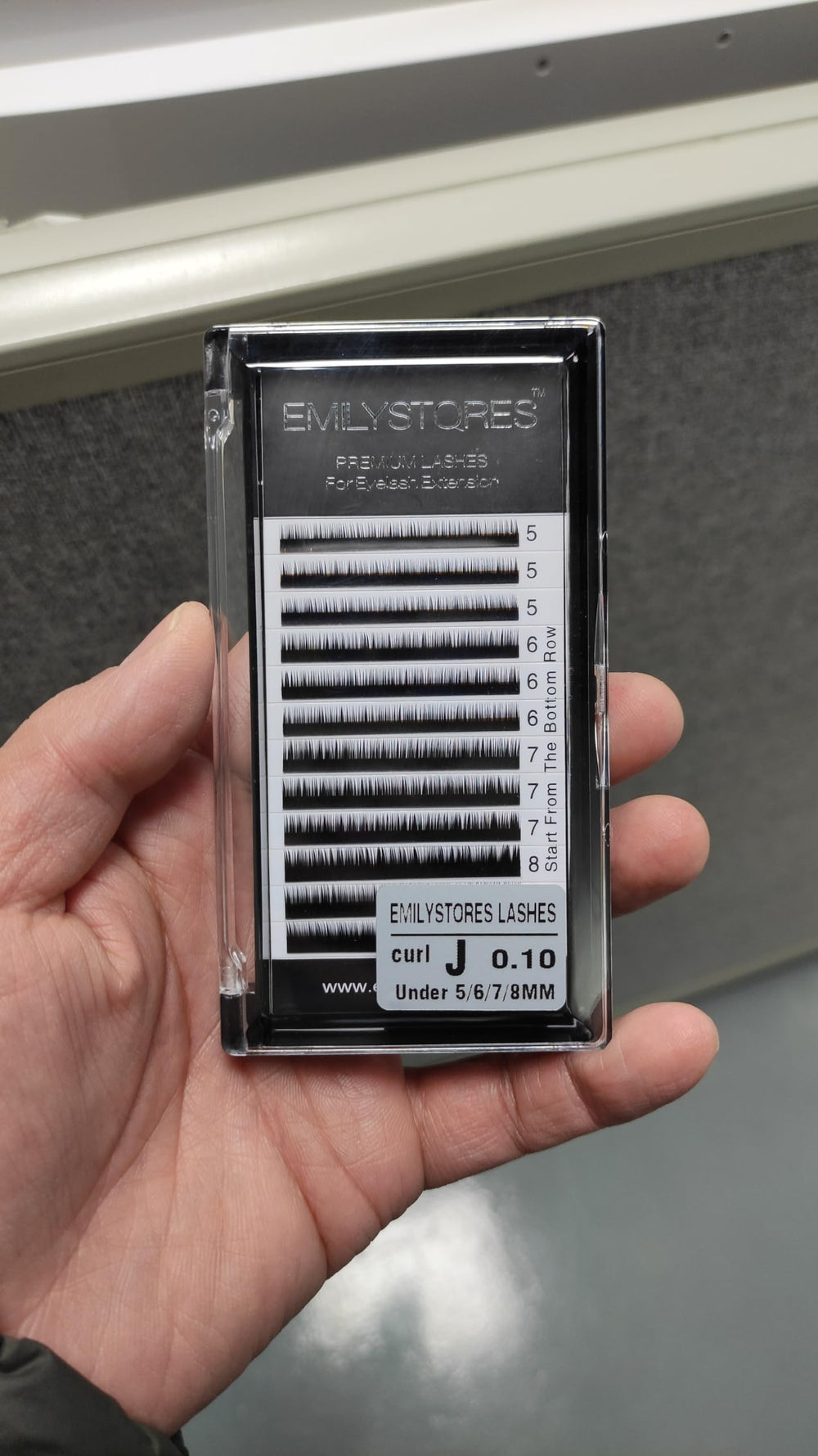 EMILYSTORES lash application with tweezers demonstrating easy placement and professional control