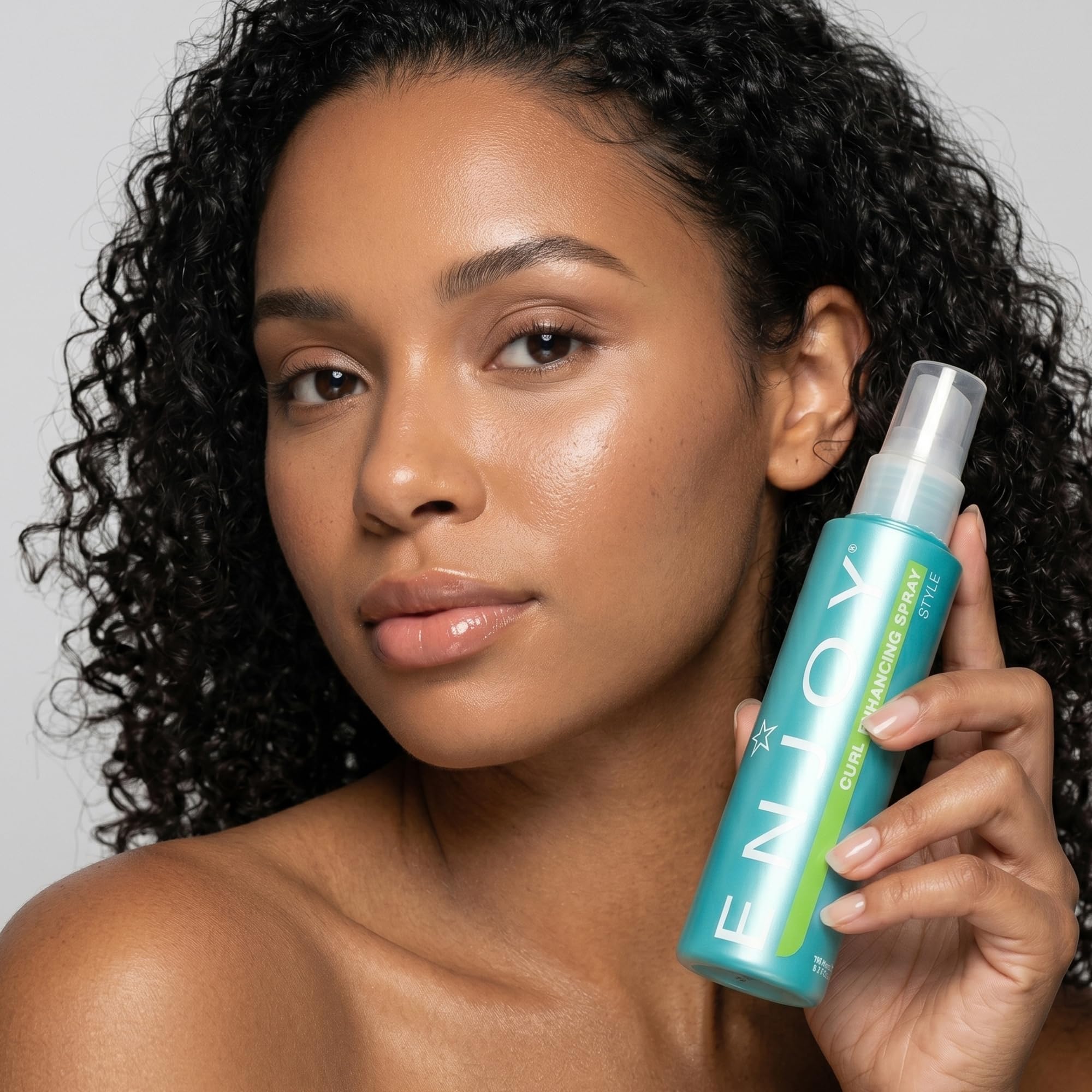 Enjoy curl enhancing spray lifestyle beach waves model showing tousled, bouncy curls and healthy shine