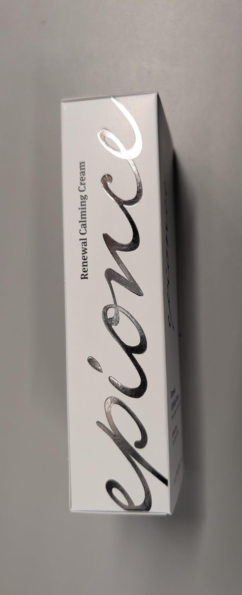 Epionce cream next to a coin for size comparison and travel-friendly convenience