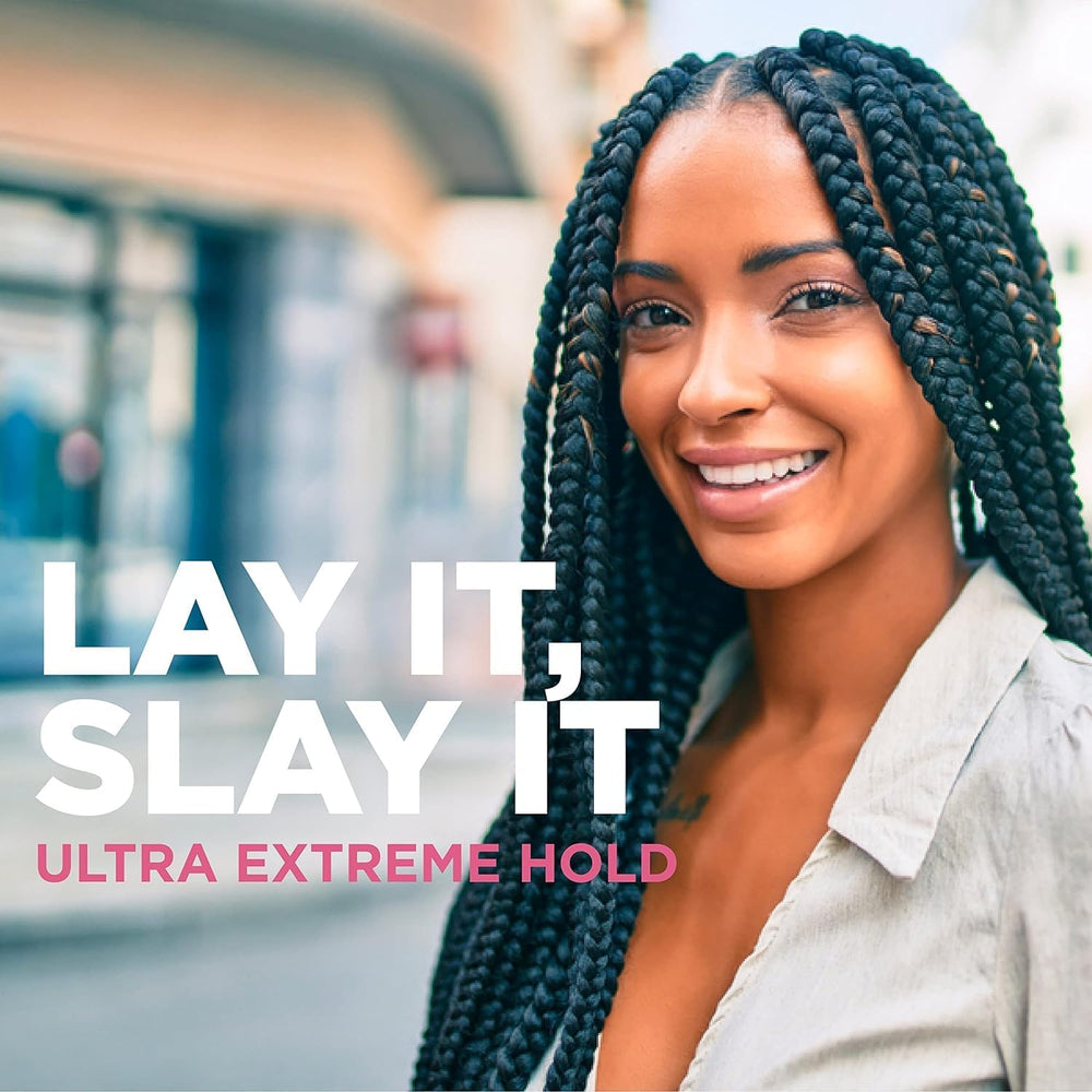 Esha Slick N Slay in a salon setting during professional braid installation