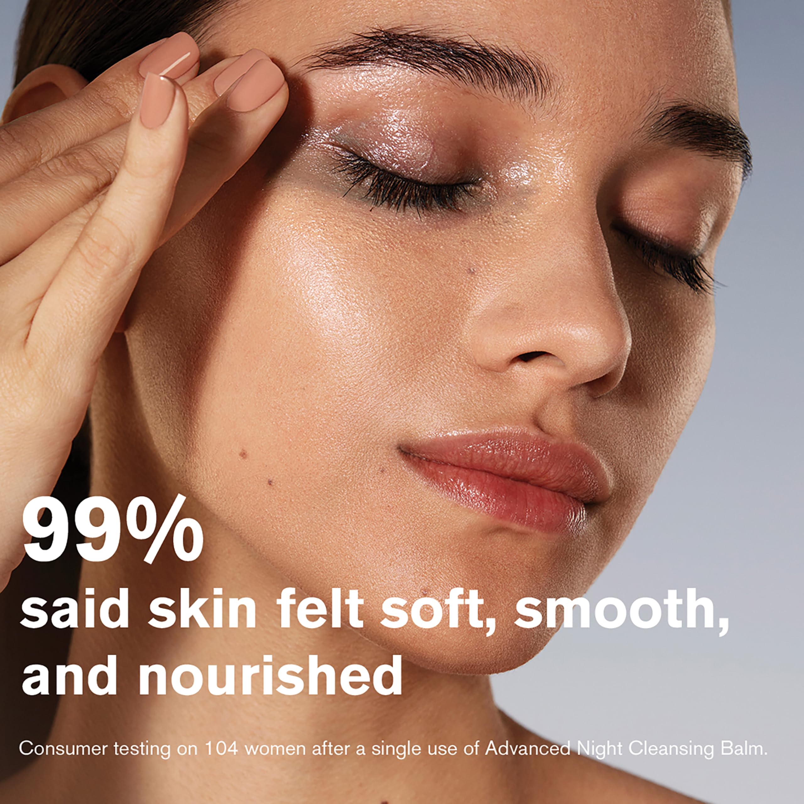 Estée Lauder balm warming on fingers demonstrating melt-to-oil action for gentle makeup removal