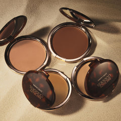 Estée Lauder bronzer applied to shoulder showing natural sun-kissed finish benefit