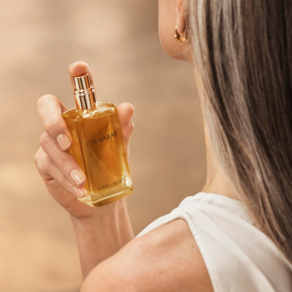 Estée Lauder Cinnabar spray on wrist showing scent testing and wear preview benefit