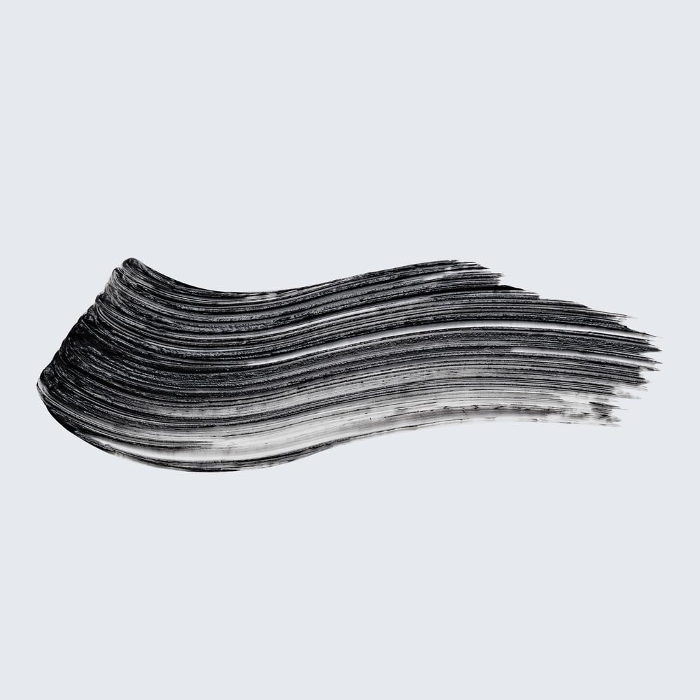 Estée Lauder close-up of primer on lashes revealing tinted black finish for visible definition