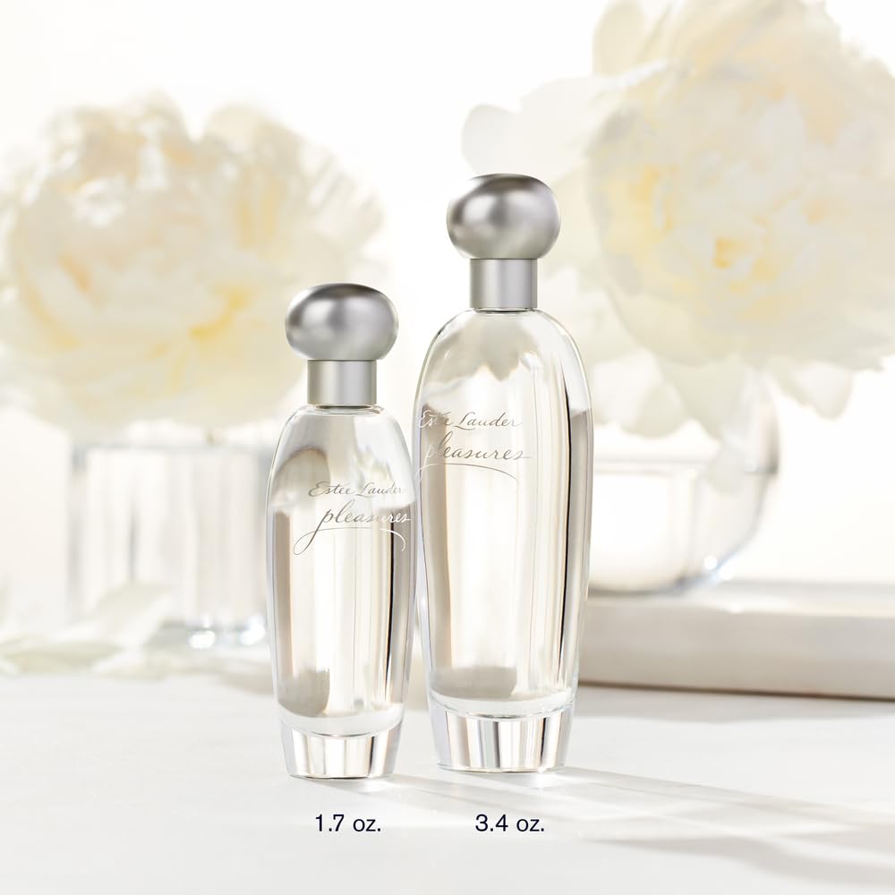 Estée Lauder Pleasures mist sprayed from bottle showing easy application and fine spray