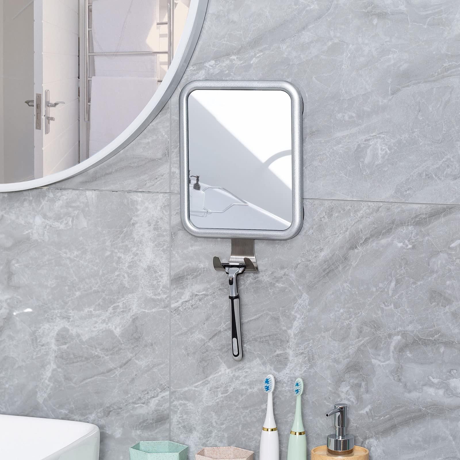 Ettori mirror held in hand for scale showing portable size benefit