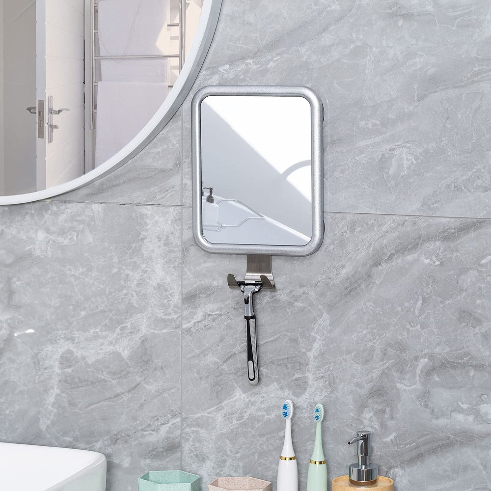 Ettori mirror held in hand for scale showing portable size benefit