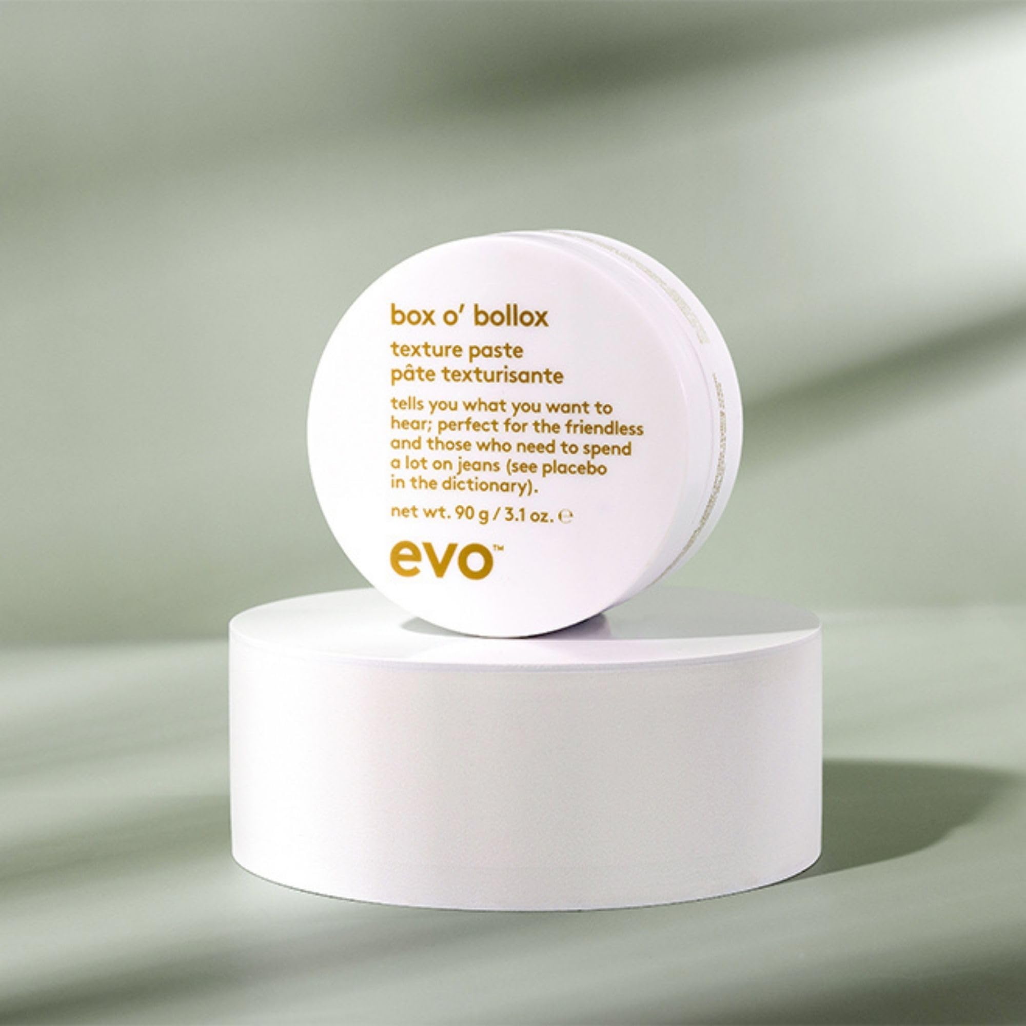 EVO Box O' Bollox next to a coin for scale highlighting the 3.1 oz travel-friendly size
