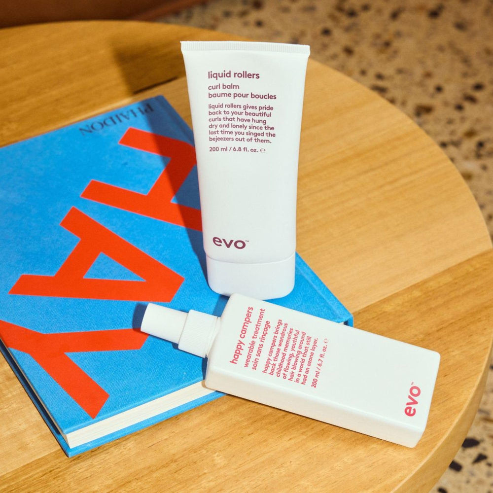 EVO Liquid Rollers being applied to damp hair to define curls and detangle