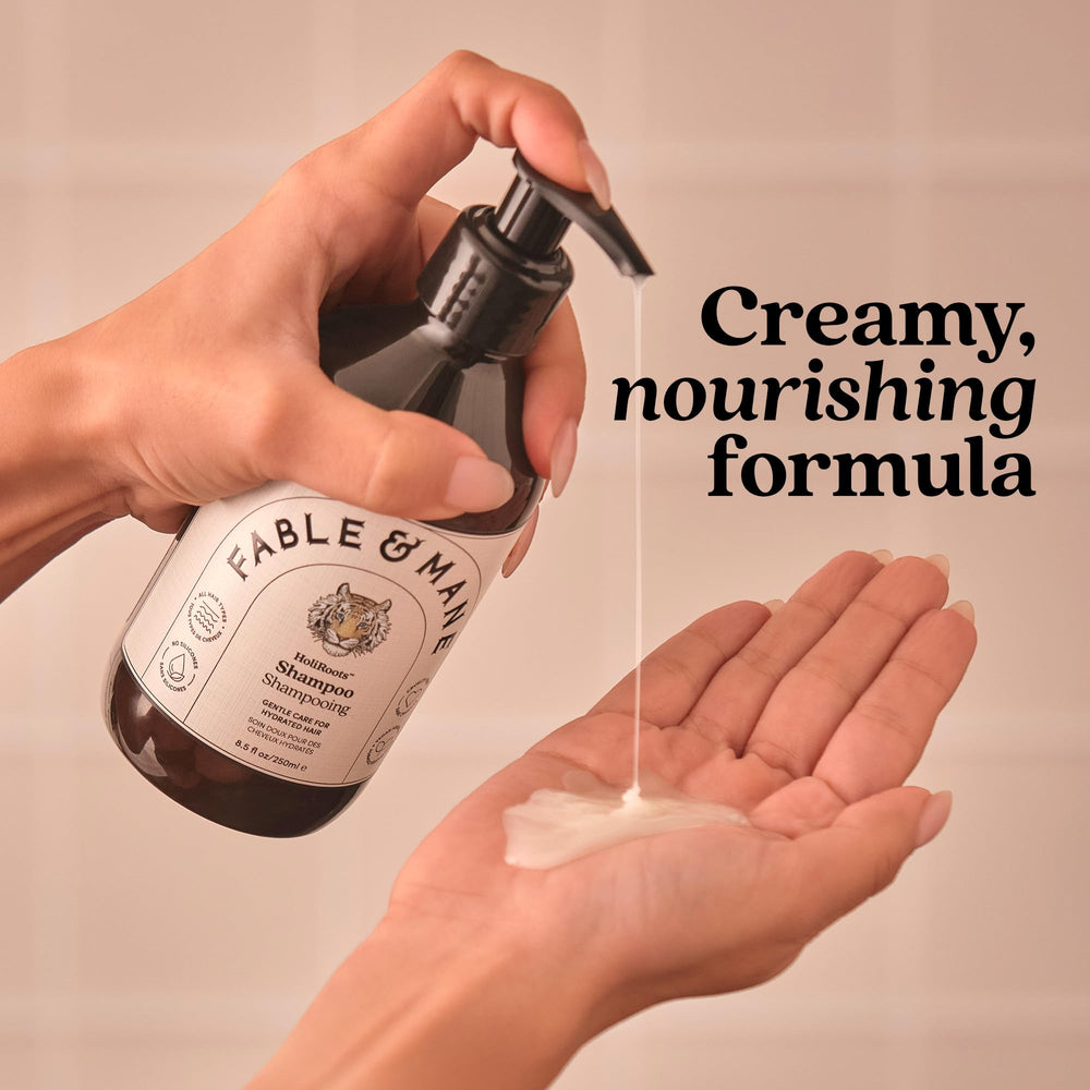 Fable & Mane bottle in hand to show size and travel-friendly scale