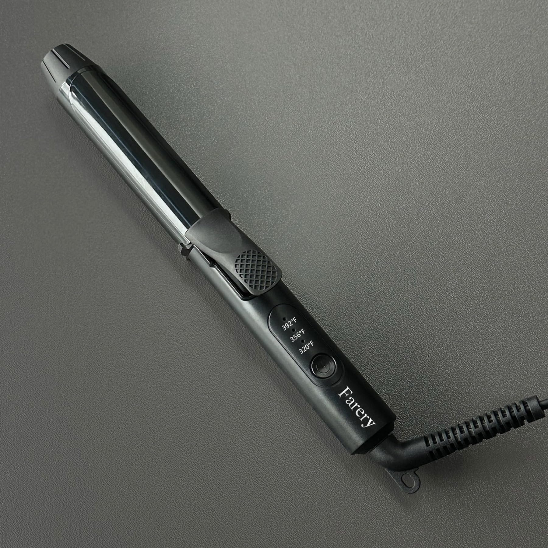 FARERY mini curling iron in hand for scale and pocketable size