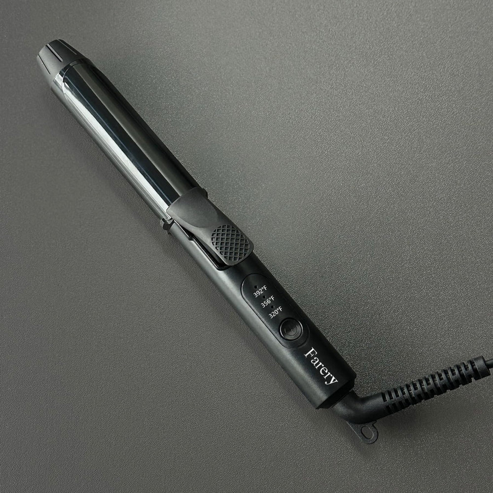 FARERY mini curling iron in hand for scale and pocketable size