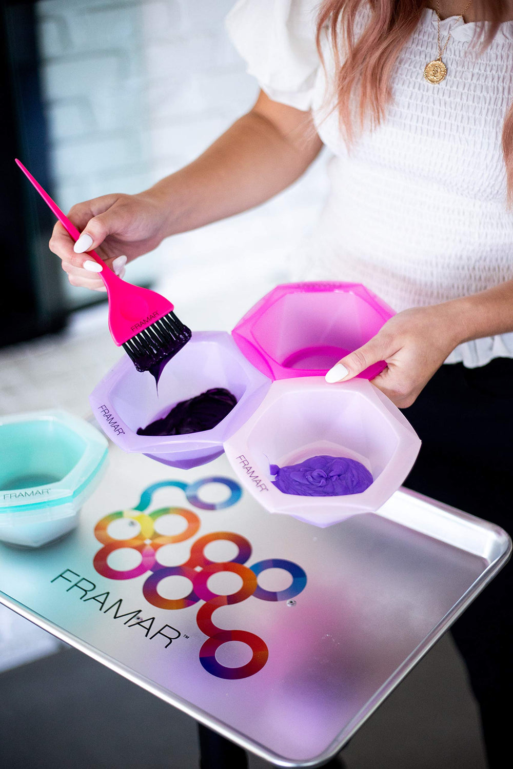 FRAMAR size comparison with brush showing compact scale and kit compatibility benefit