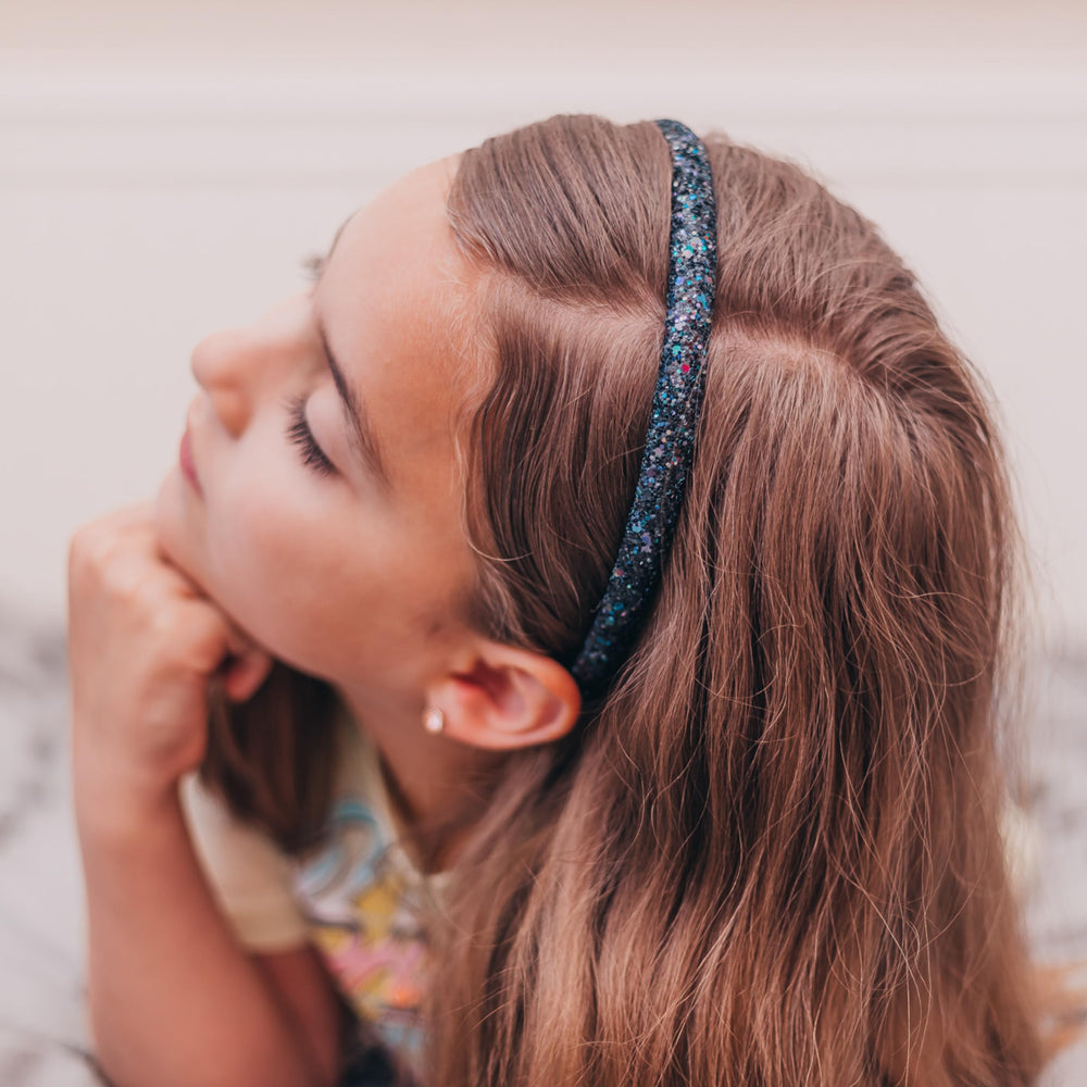 FROG SAC girl wearing headband outdoors for secure hold and playful style