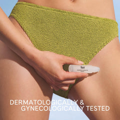 Fur rollerball being applied to leg to target ingrown hairs and soothe skin