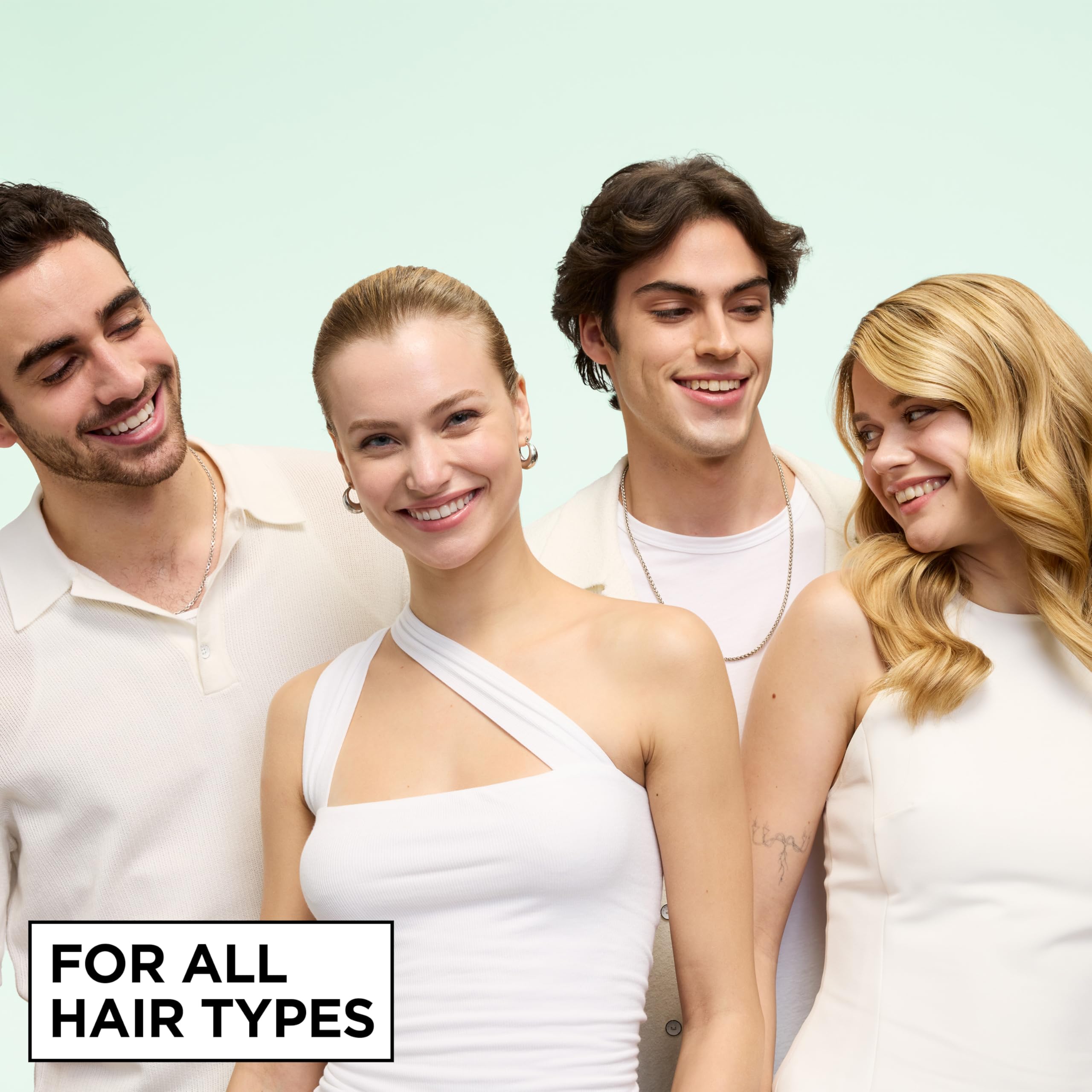 Garnier Fructis held in hand to show true size and travel-friendly benefit