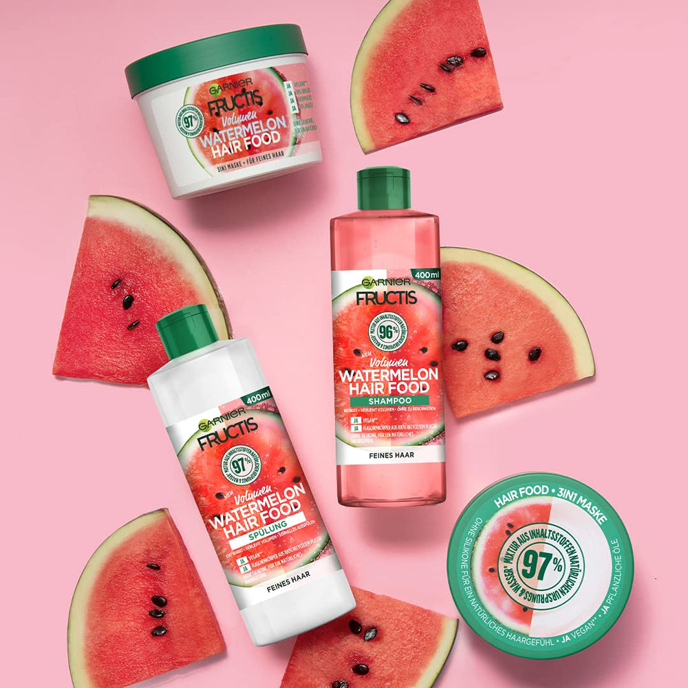 Model applying Garnier Fructis Watermelon Hairfood to fine hair for added volume and shine