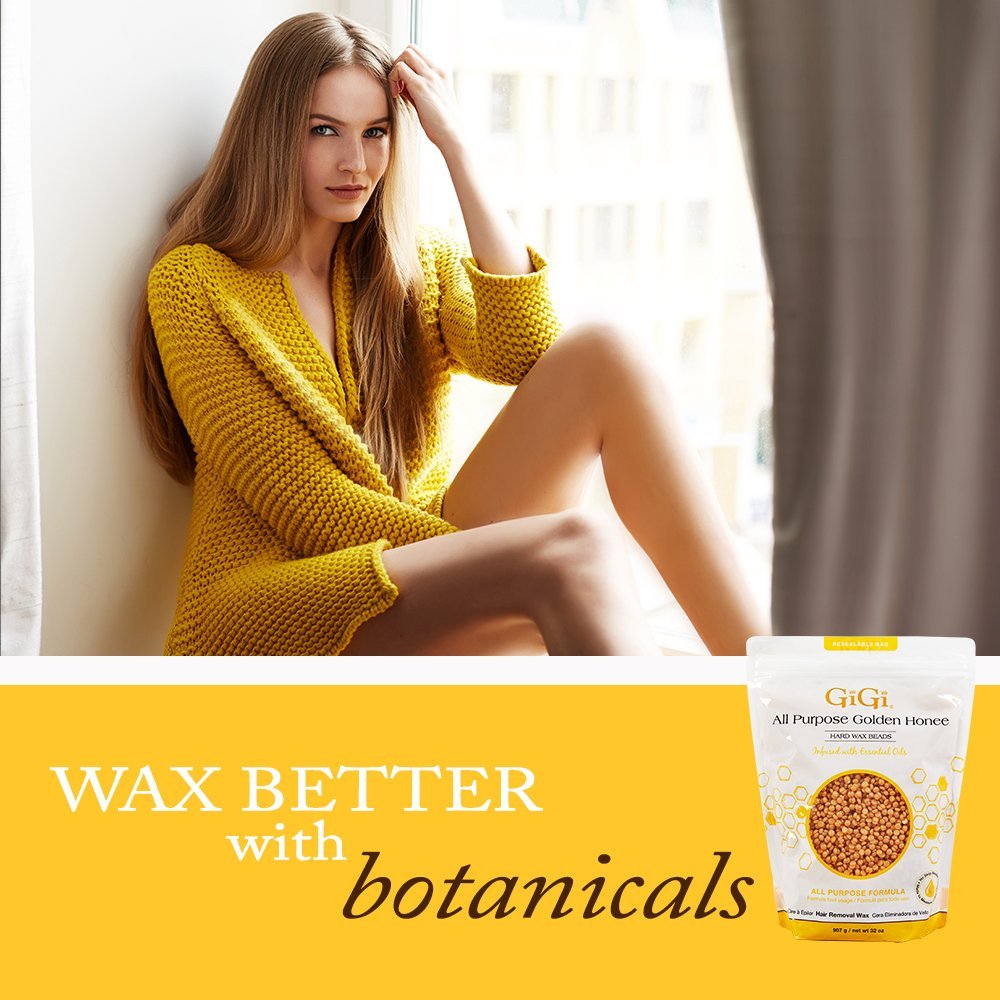 GIGI heated wax on wooden spatula showing creamy consistency for controlled application