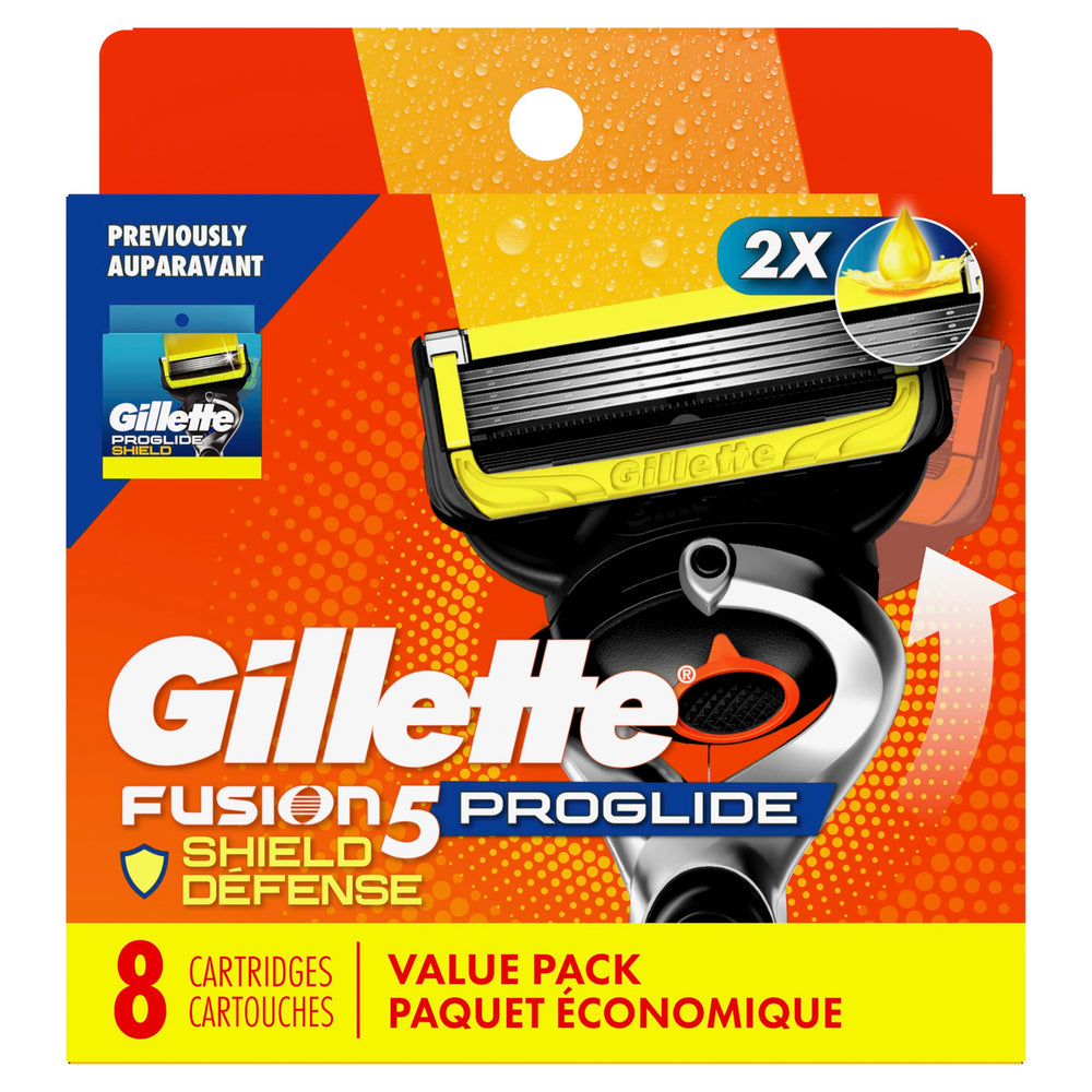 Gillette cartridge next to coin for size comparison showing compact, travel-friendly design