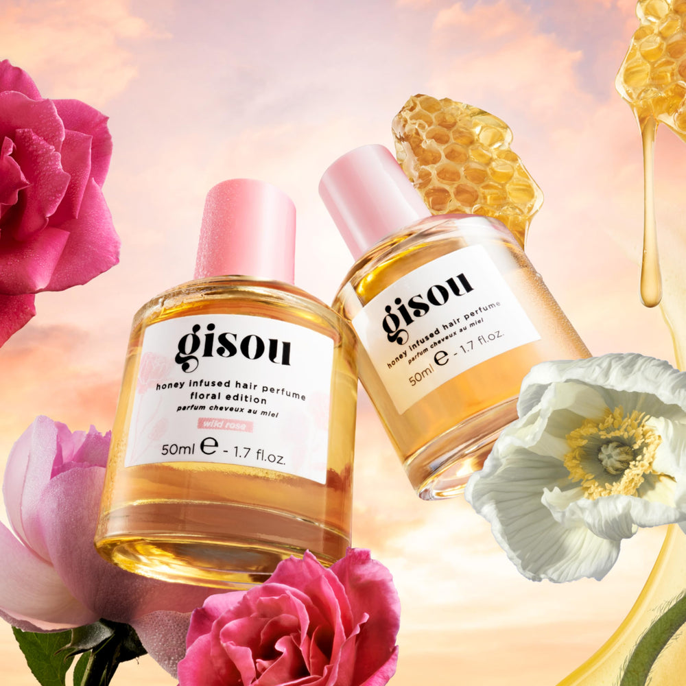 Gisou bottle staged in a garden to reflect natural, wildflower-inspired fragrance