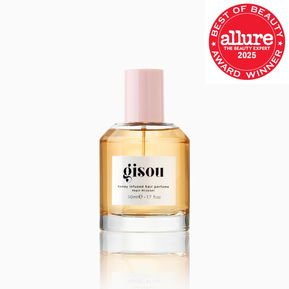 Gisou mist spraying from bottle demonstrating fine even distribution for shine