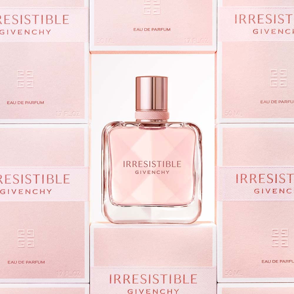 Givenchy Irresistible next to a hand for scale shows 2.7 oz travel-friendly size
