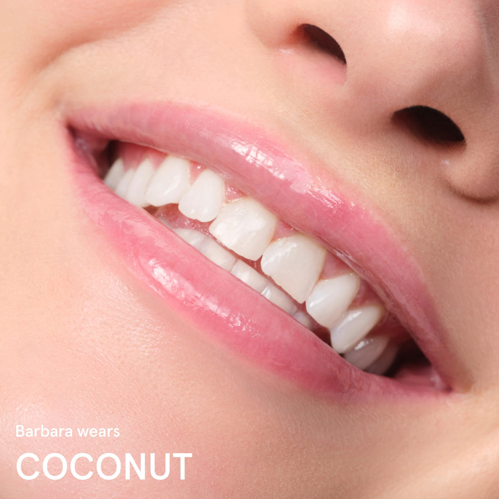 Glossier balm dotcom coconut applied to cuticles for soft, nourished skin