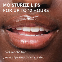 Glossier Balm Dotcom cap off revealing smooth lanolin-rich texture and easy application