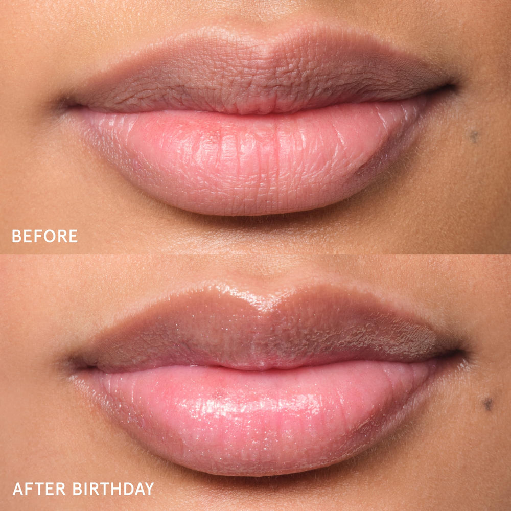 Glossier Balm Dotcom tube in hand illustrating travel size convenience