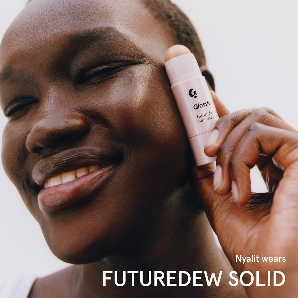 Glossier Futuredew solid tucked inside travel bag for touch-up ready glow
