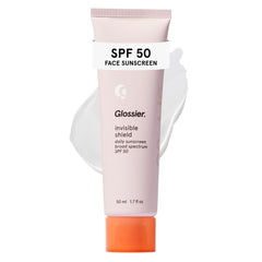Glossier Invisible Shield front packaging shows compact 50 mL tube and clean design benefit: clear SPF protection
