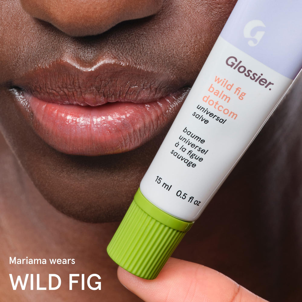 Glossier Balm Dotcom tucked inside a small purse demonstrating on-the-go hydration convenience