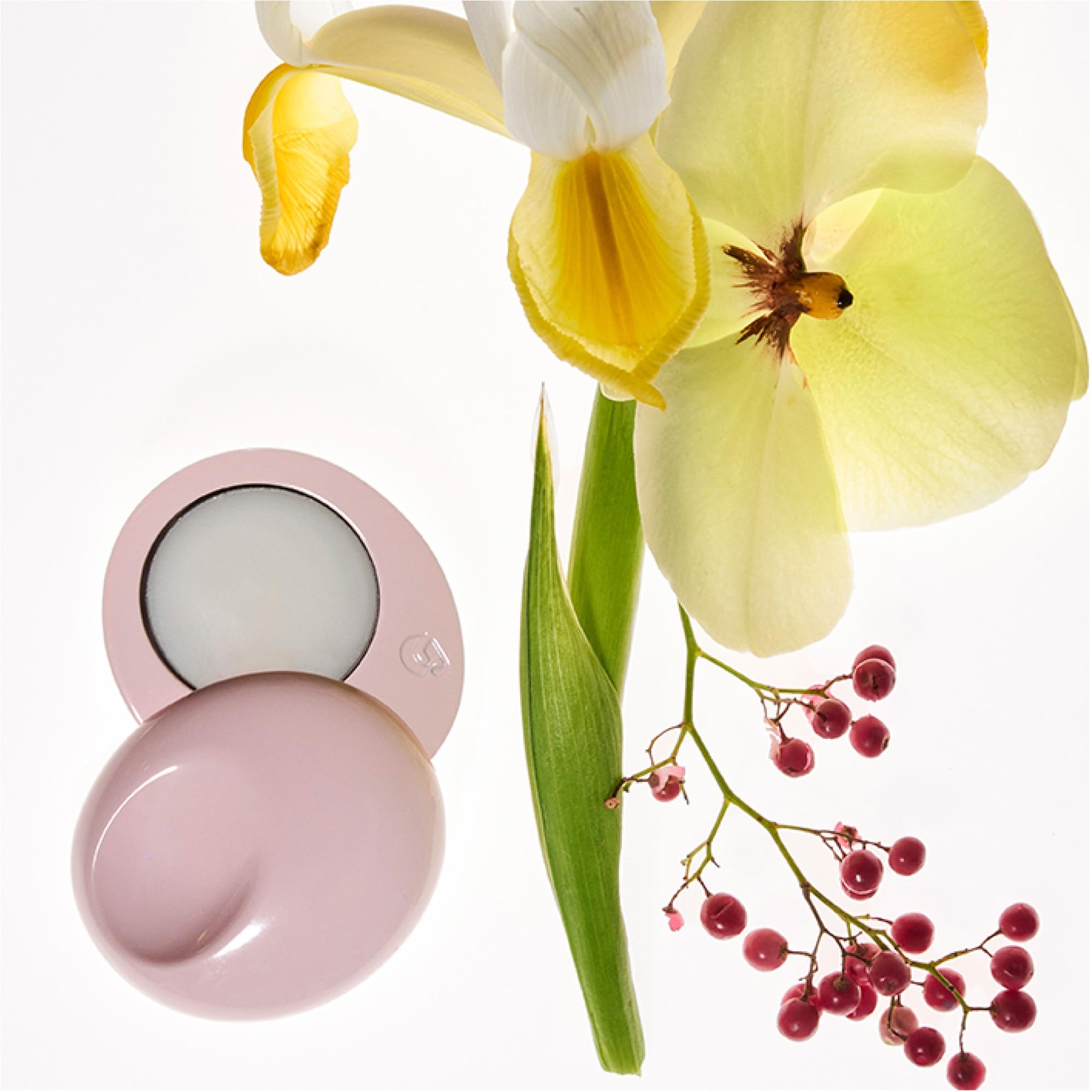 Glossier compact sitting on a handbag showing on-the-go use benefit: discreet touch-ups