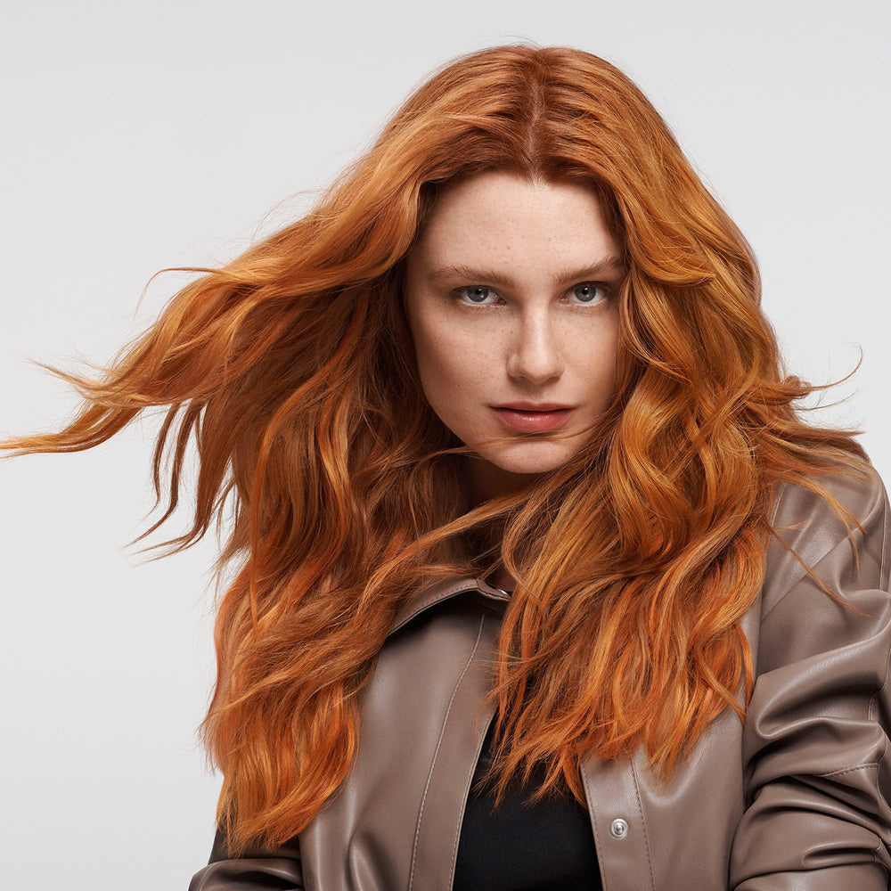 Goldwell applying conditioner to mid-lengths and ends for improved detangling