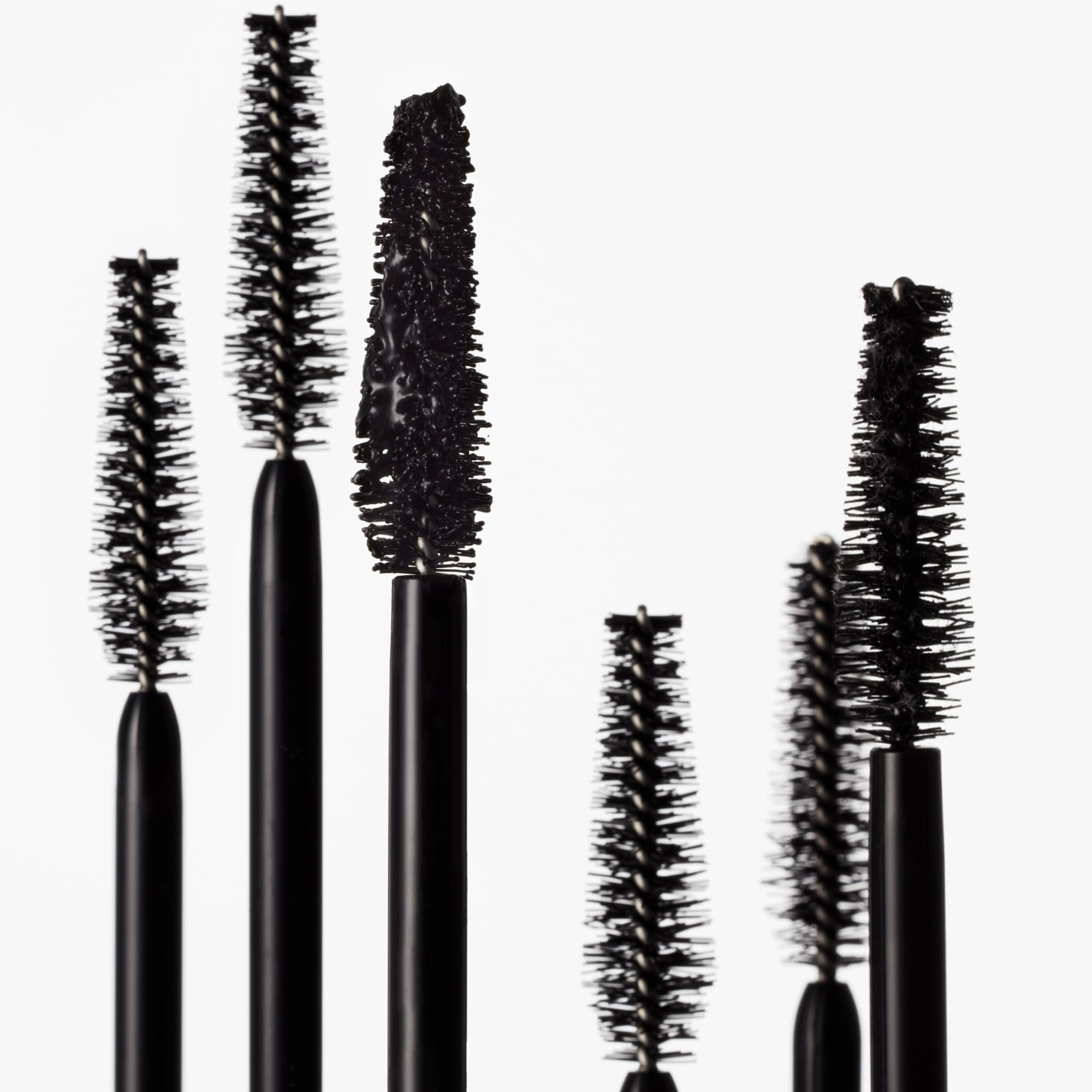goop Featherlash next to a ruler to show compact 0.15 fl oz size