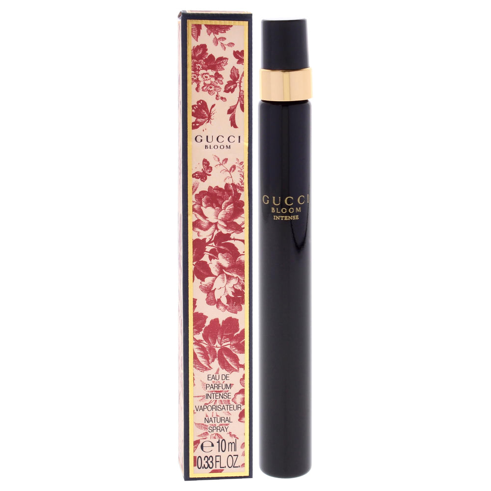 Gucci Bloom Intense mini bottle next to keys showing compact 10 ml scale convenience