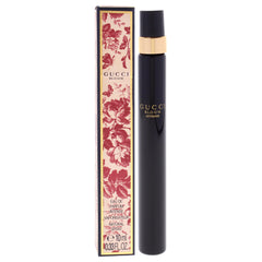 Gucci Bloom Intense mini bottle next to keys showing compact 10 ml scale convenience