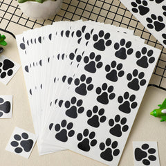 Harloon paw tattoo on hand for scale, shows actual size and visible contrast