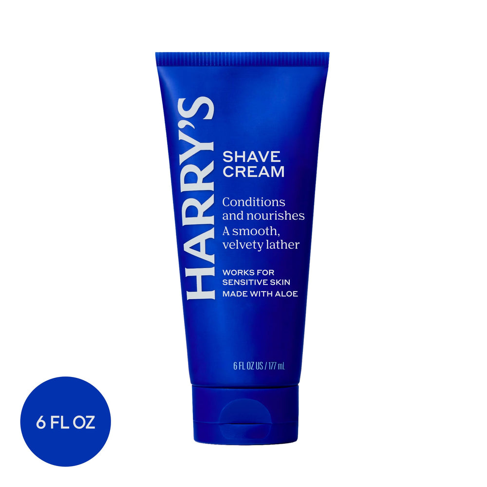 Harry's shave cream beside razor and brush to show precision shaving setup