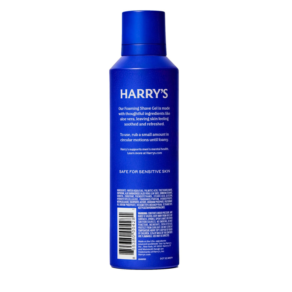 Harry's can beside a hand to show 6.7 oz size for scale and portability